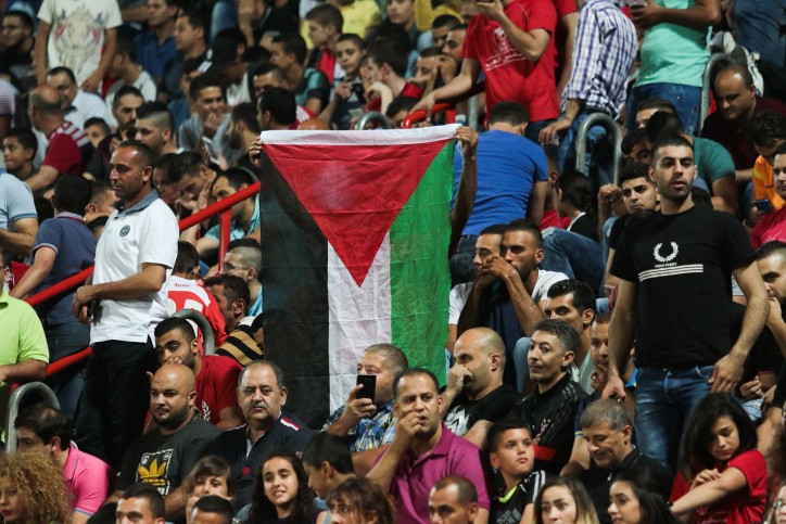 אוהדי בני סכנין עם דגל אש"ף | צילום: רוי אלימה, פלאש 90
